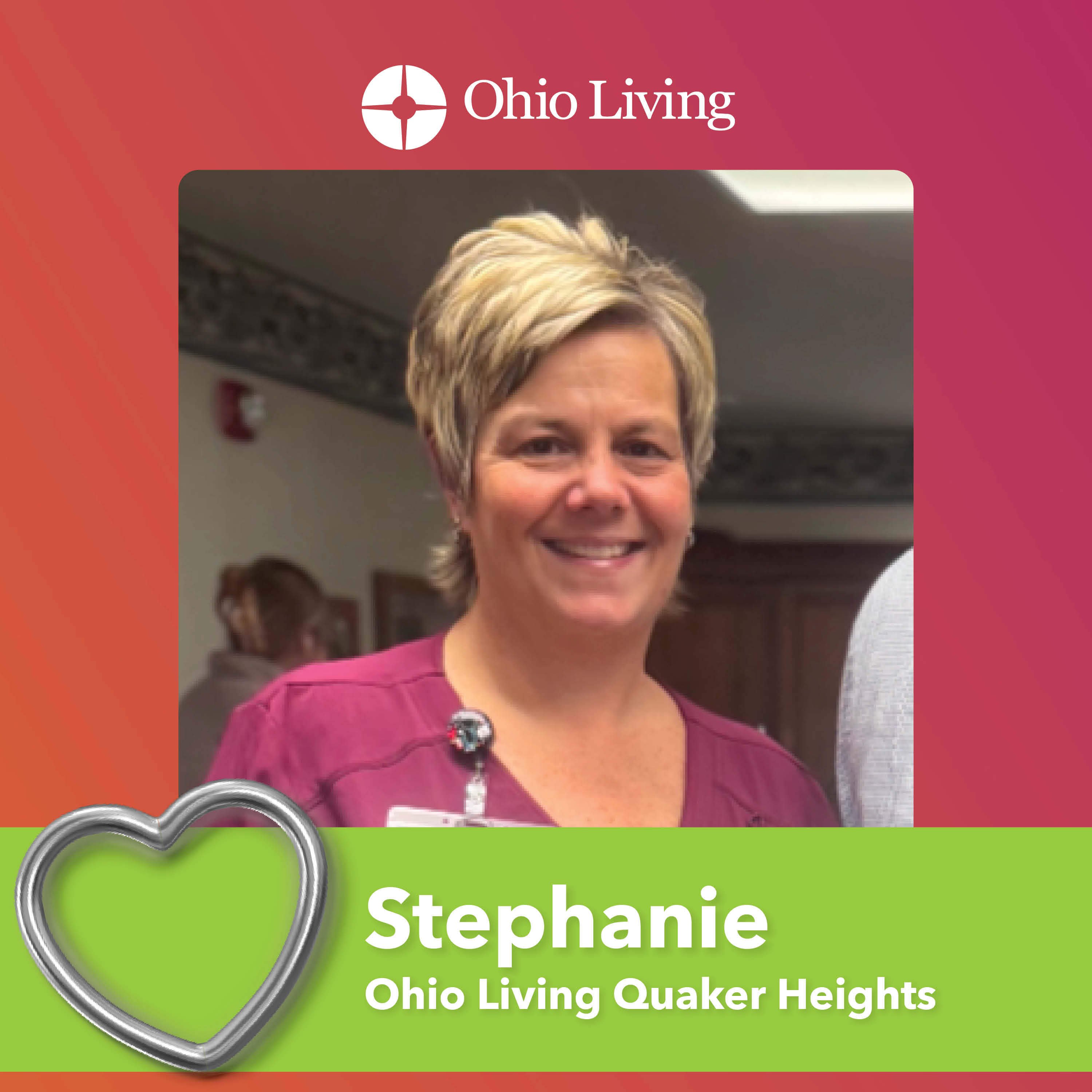 Graphic featuring a smiling woman with short blonde hair indoors, wearing a maroon top and name badge. The Ohio Living logo appears at the top. Text reads “Stephanie” and “Ohio Living Quaker Heights,” with a heart icon on a green background.